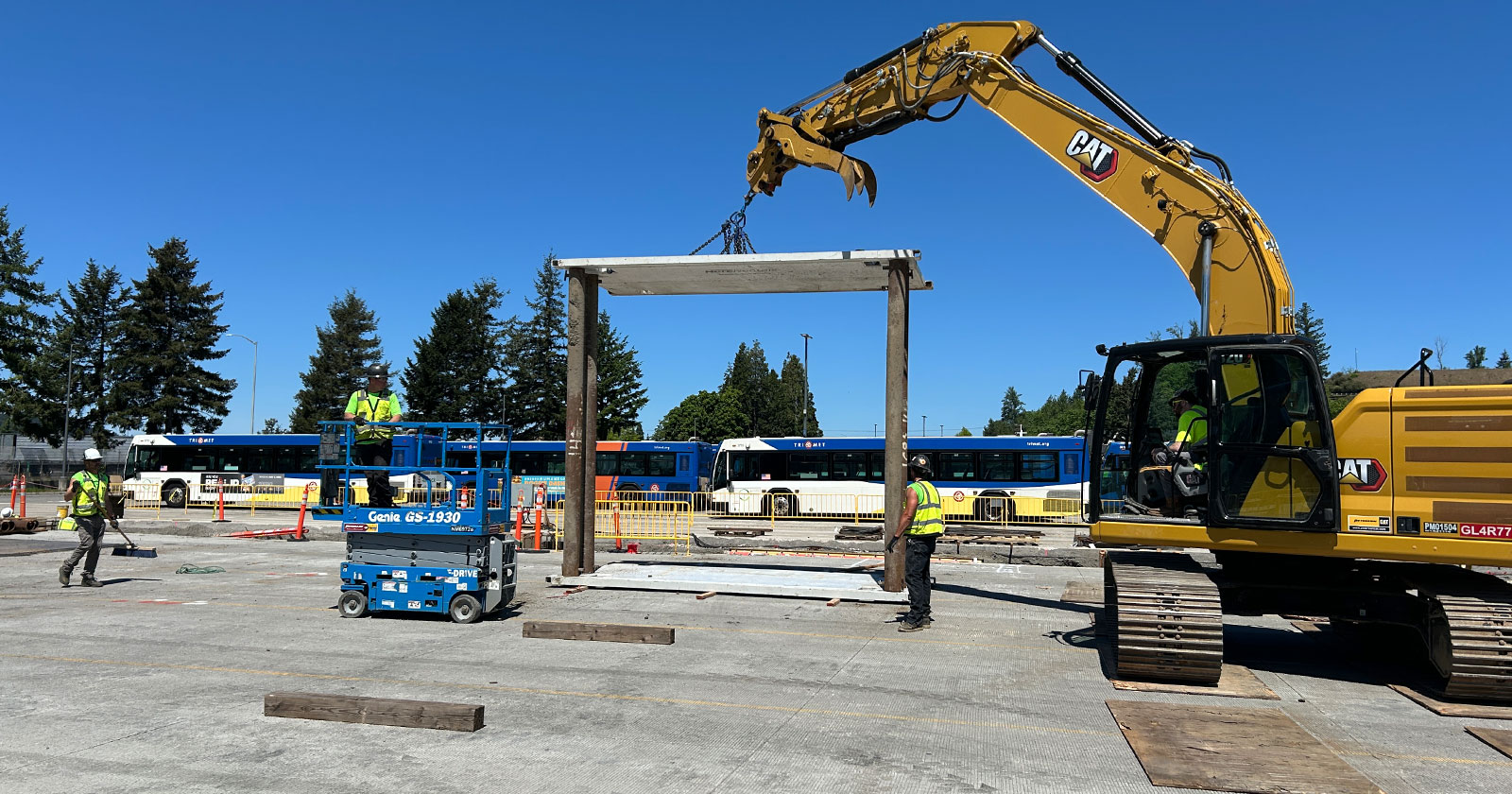 Construction workers and a crane at a construction site